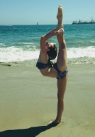Kerris Dorsey doing Gymnastic pose on the beach in Bikini
