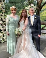 Paige Howard with parents on her wedding day